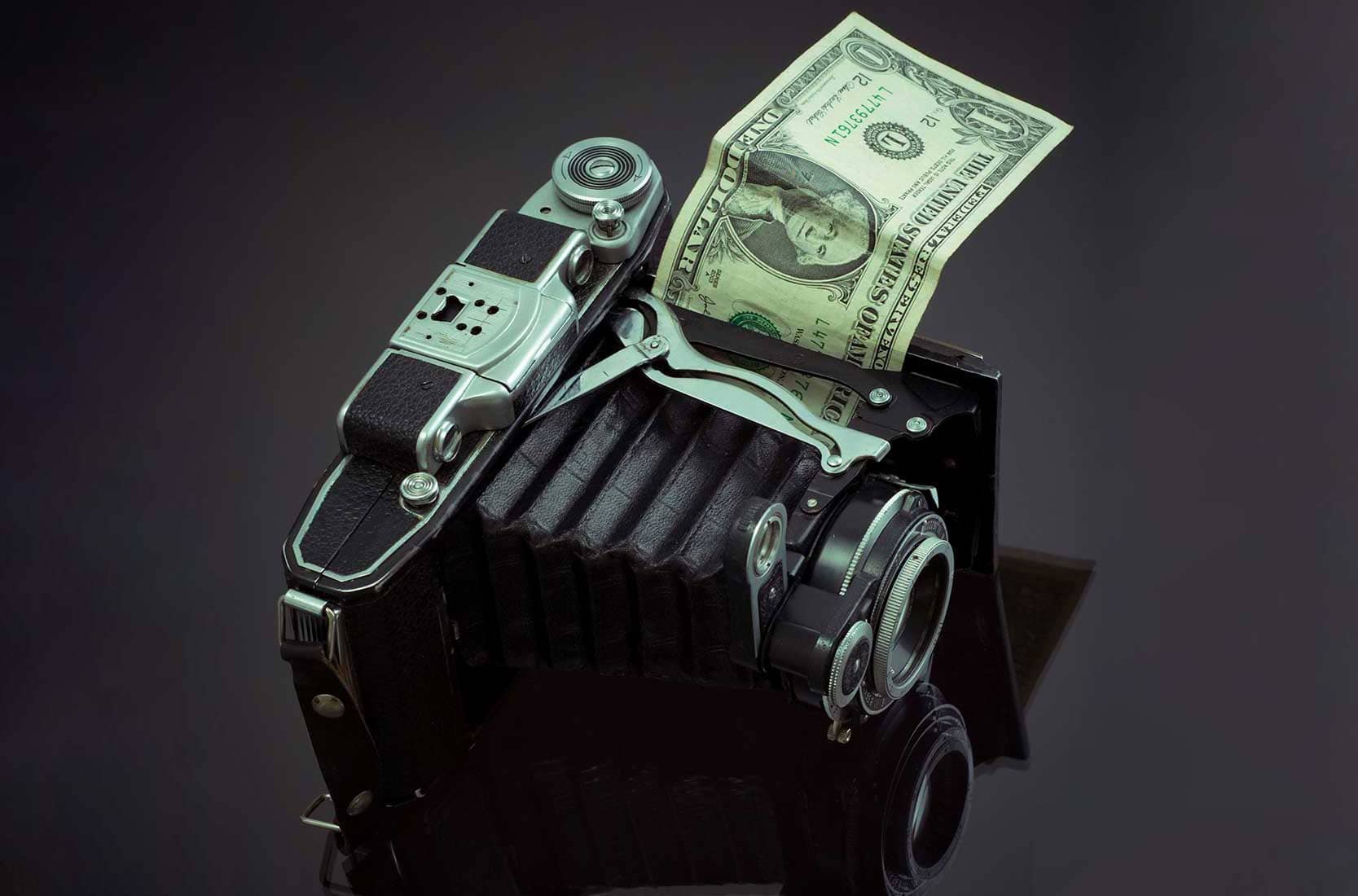 Vintage camera with a dollar bill sticking out